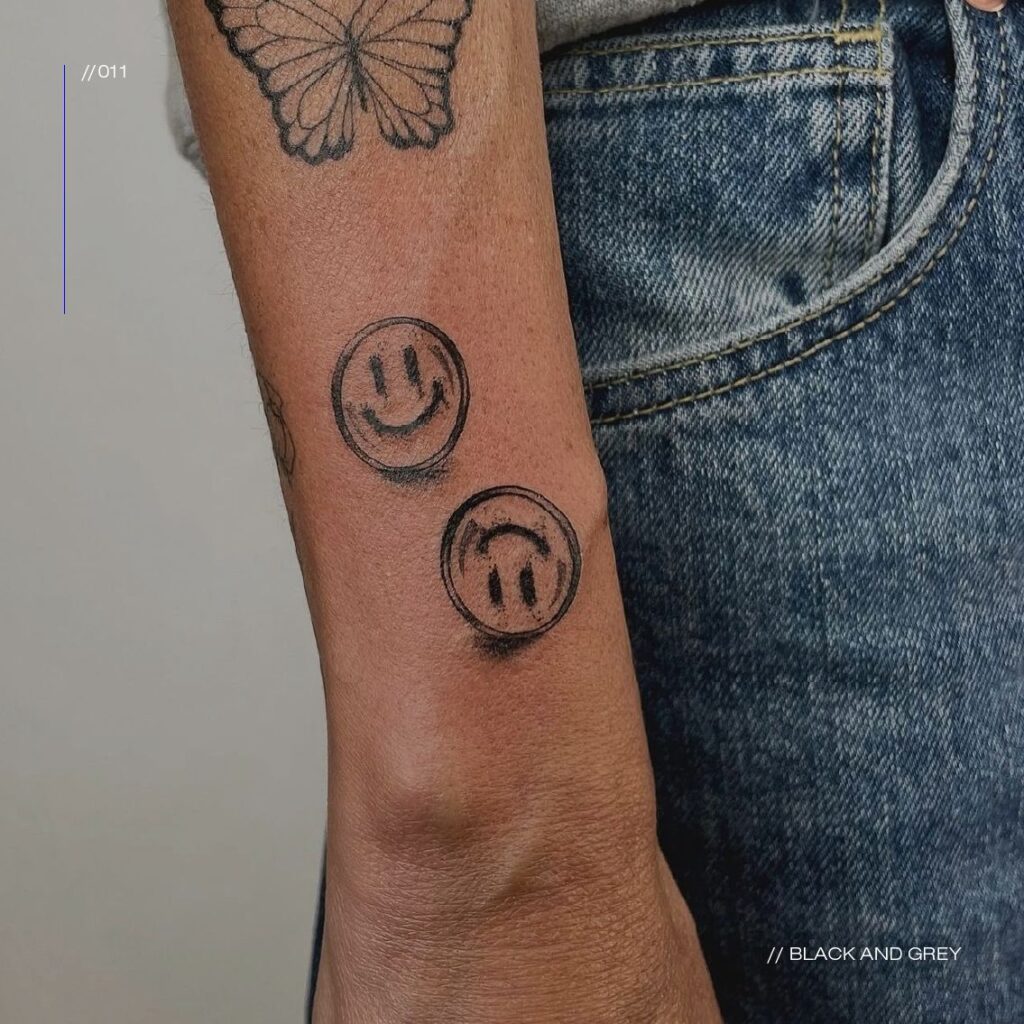 black and grey smiley tattoos